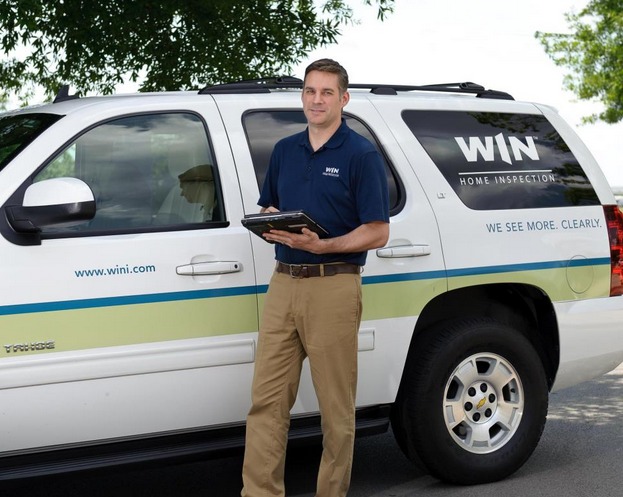 WIN home inspector in front of WIN van