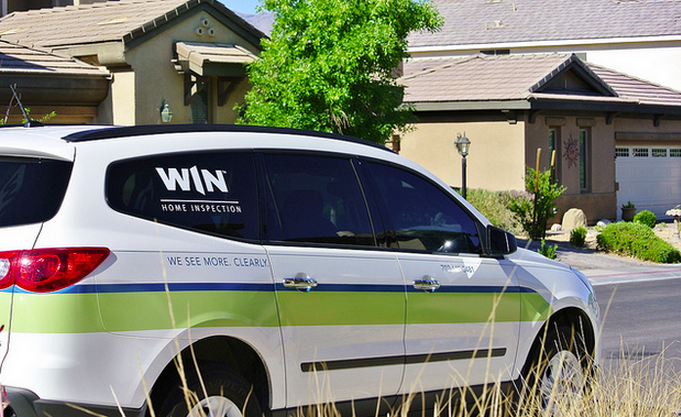 WIN van in front of homes