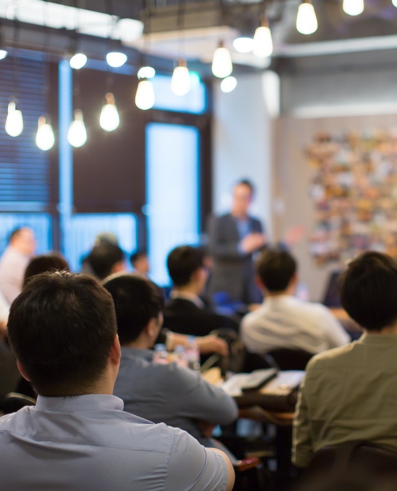 Presenter Presenting on Stage at Conference Meeting