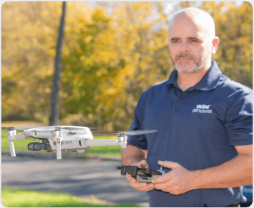 home inspector flying drone for inspecting roof