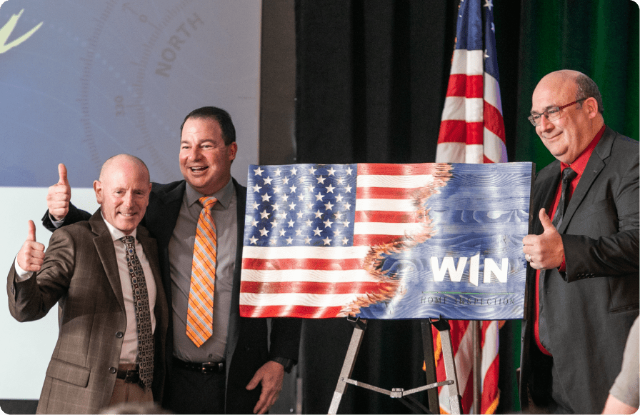 Veterans holding US Flag with WIN logo on it