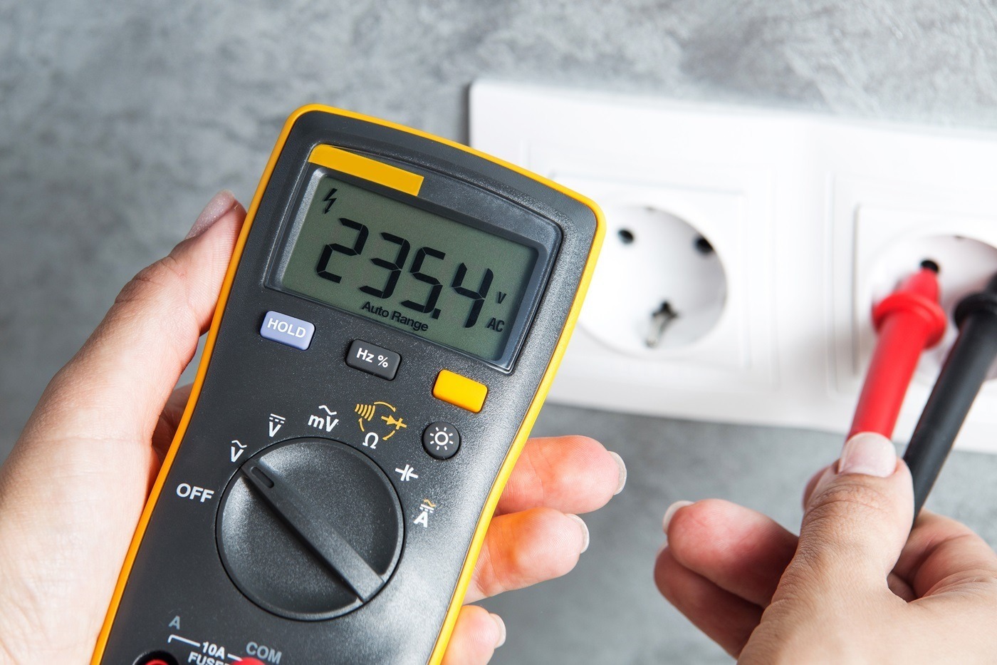 voltage tester testing the voltage through an electrical socket