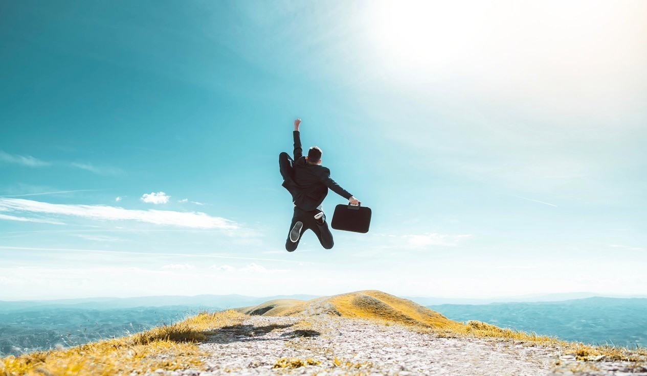 Person jumping in the air in an open wide sky