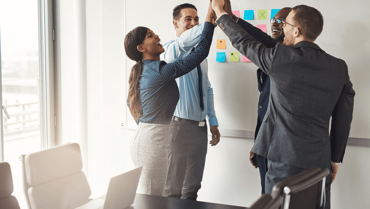 Successful business team givng high five to each other