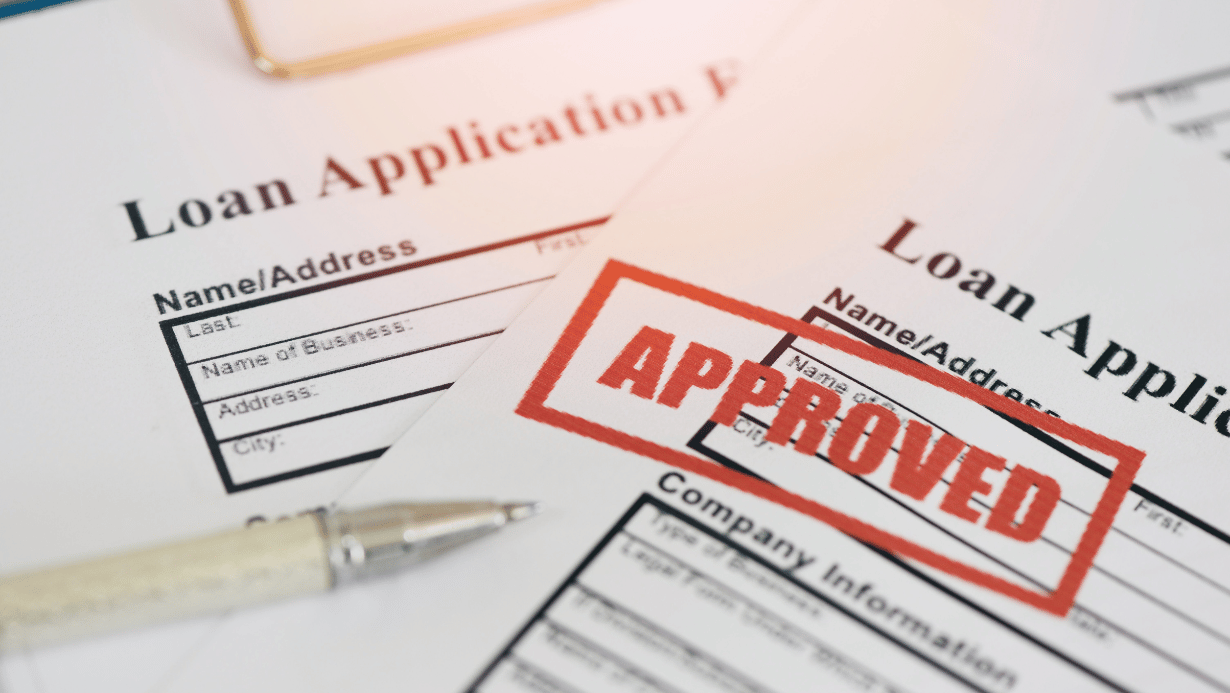 Loan approval, Loan application form with Rubber stamping that says Loan Approved, Financial loan money contract agreement company credit or person.