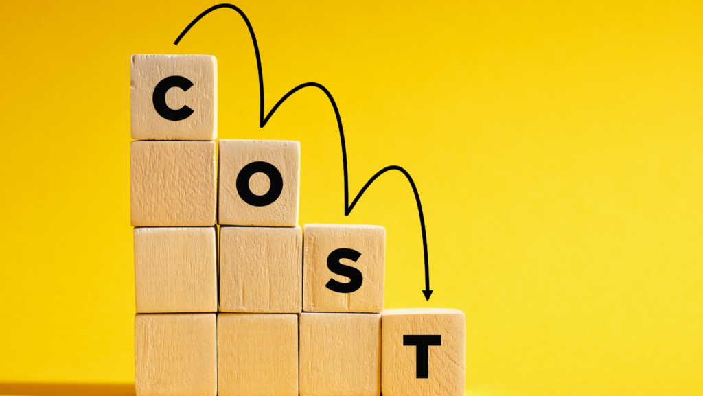 a stack of wooden blocks with letters on them 'COST'